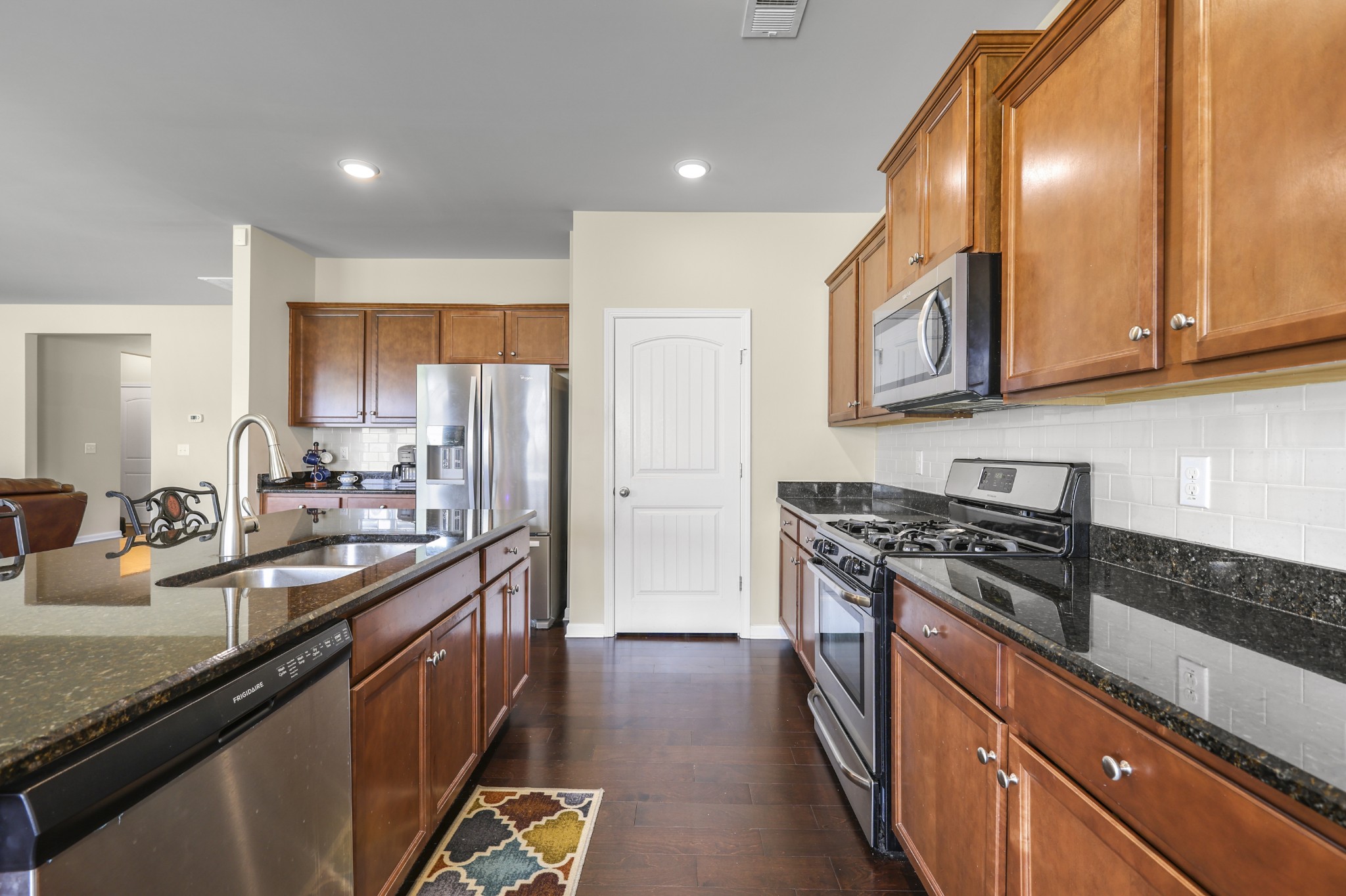 6515 Tulip Tree Drive Murfreesboro, TN 37128 - Photo 8 of 21 a kitchen with stainless steel appliances granite countertop a stove a sink and a refrigerator