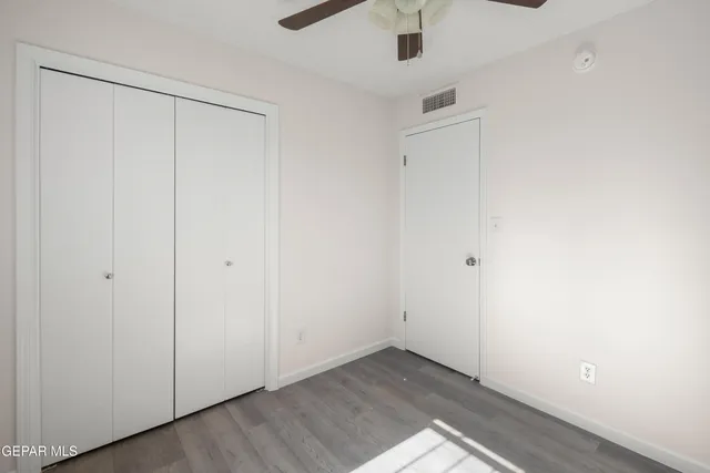 an empty room with ceiling fan