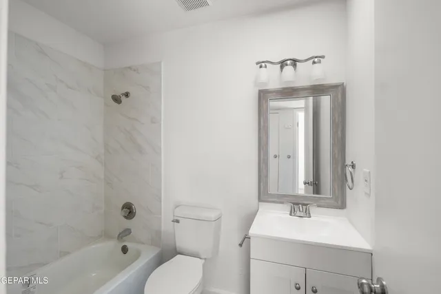 a bathroom with a sink a toilet and bathtub