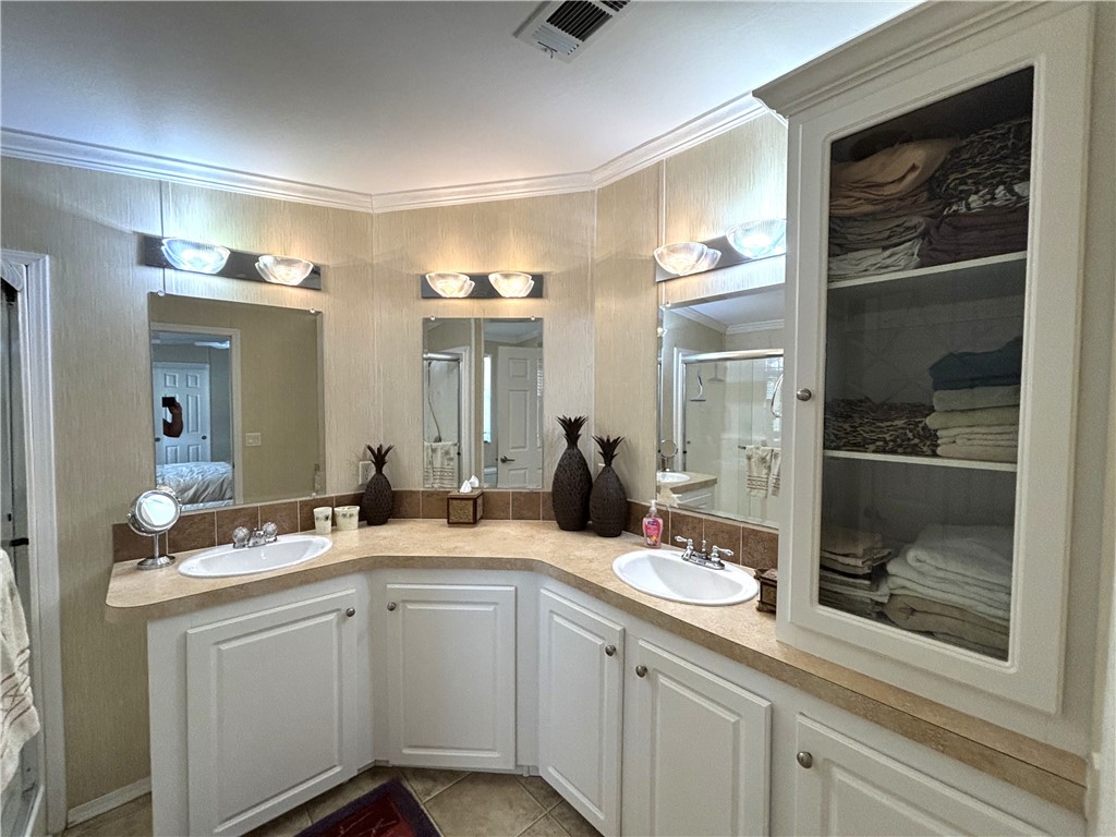 6171 98th Road Sebastian, FL 32958 - Photo 12 of 14 a bathroom with a sink a mirror and a shower