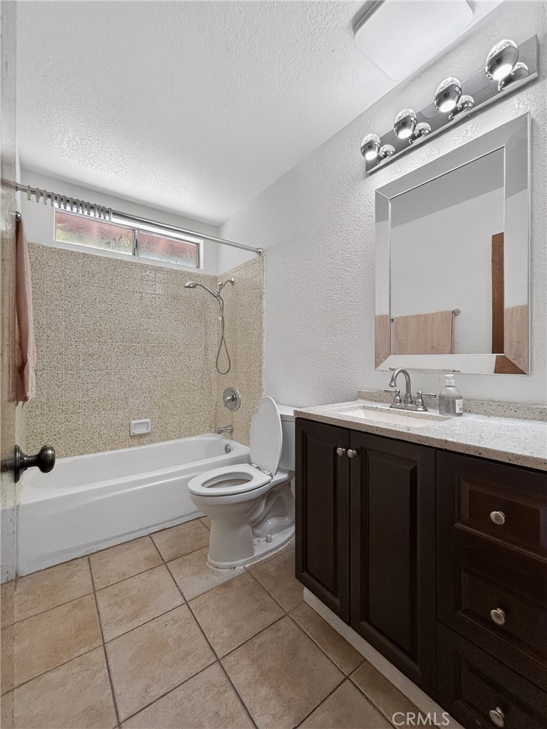 7451 Diamond Street Riverside, CA 92504 - Photo 22 of 31 a bathroom with a sink a toilet and shower