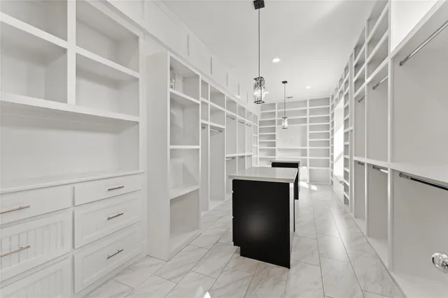 a view of a kitchen with refrigerator and wooden floor