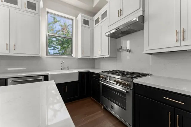 a kitchen with stainless steel appliances granite countertop a stove and a sink