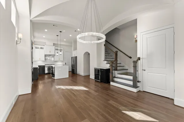 a view of a hallway with kitchen and entryway