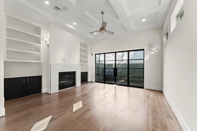 a view of an empty room with a fireplace and a window