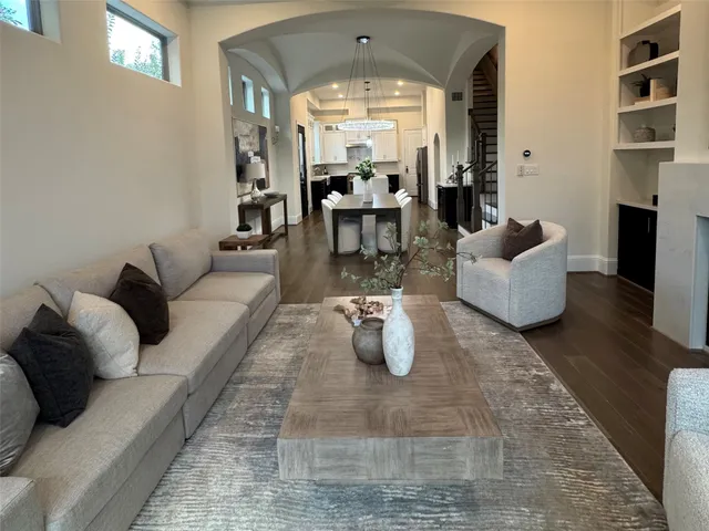 a living room with fireplace furniture and a chandelier