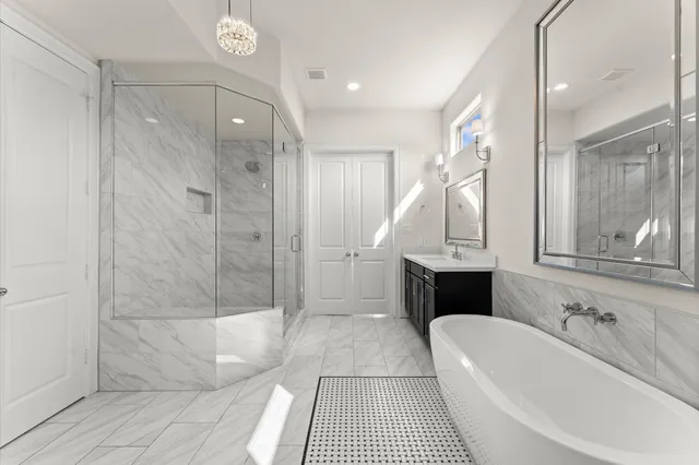 a bathroom with a bathtub a sink a toilet and a shower