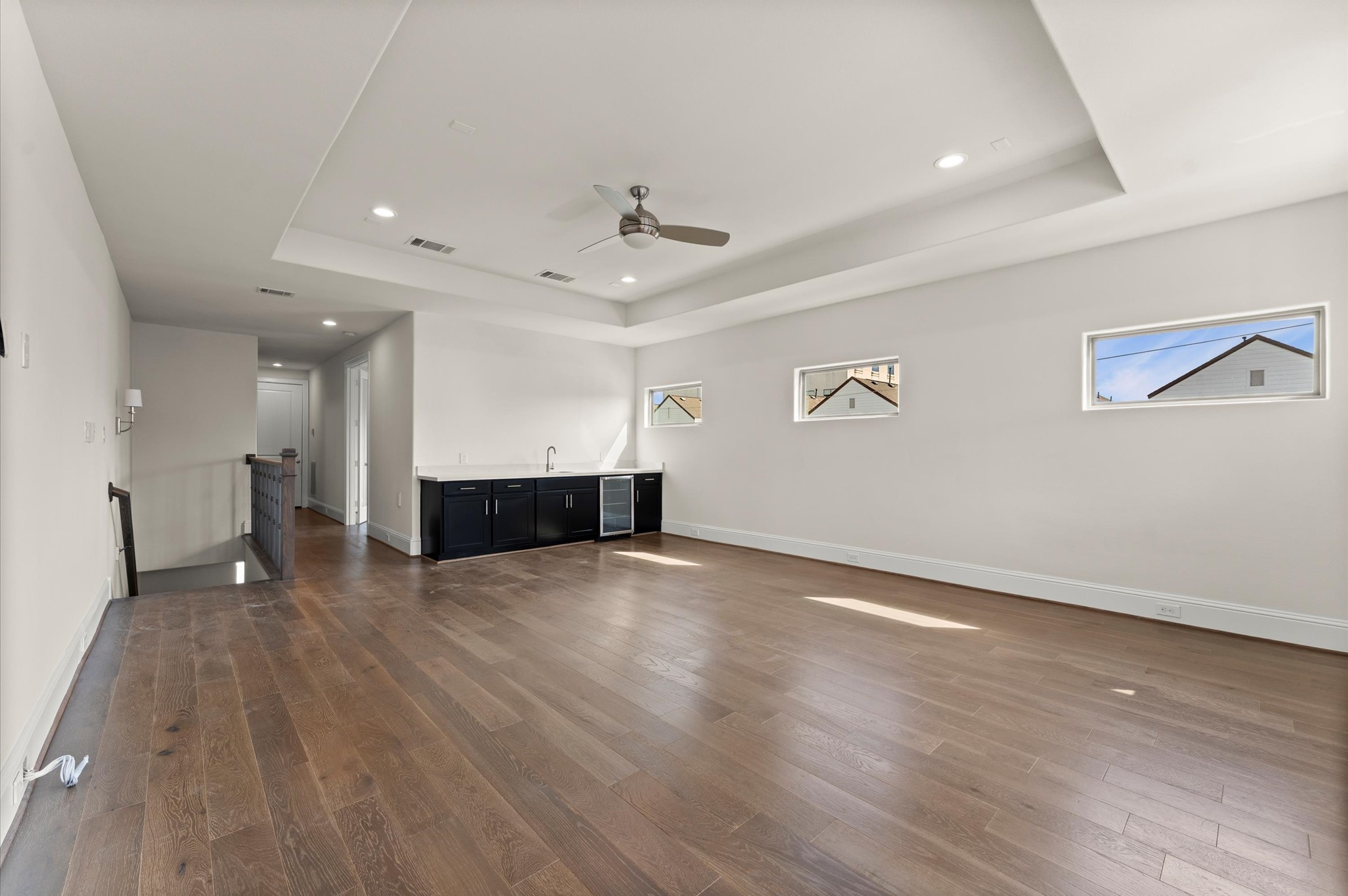 1902 West 25th Street Houston, TX 77008 - Photo 39 of 49 a view of an empty room with wooden floor and a ceiling fan