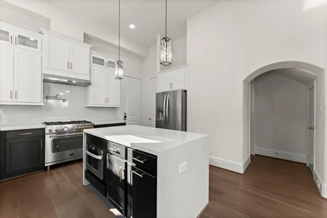 a kitchen with stainless steel appliances granite countertop a sink stove and refrigerator