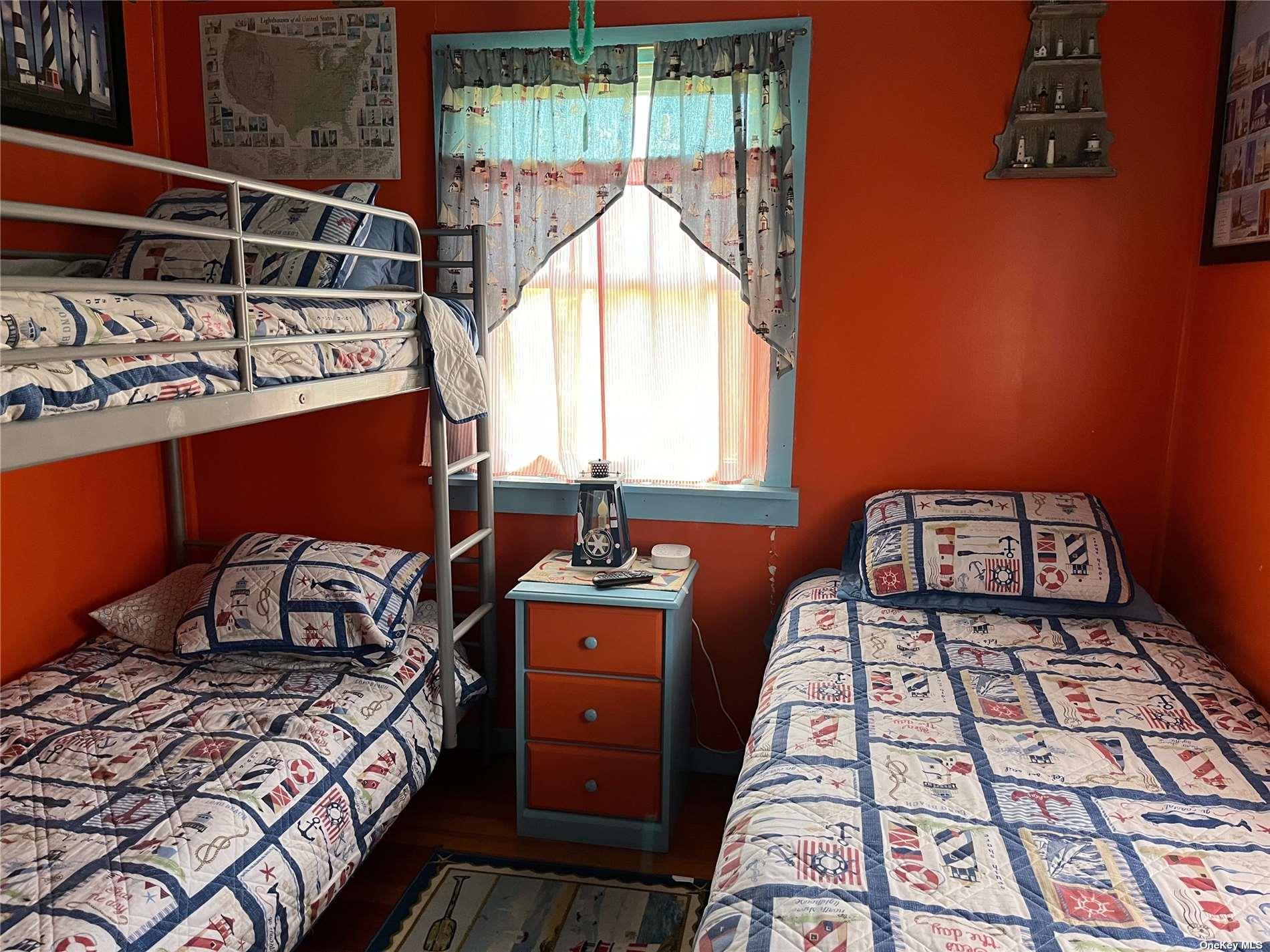 4 Surf View Walk Ocean Beach, NY 11770 - Photo 12 of 15 a bedroom with a bed next to a window