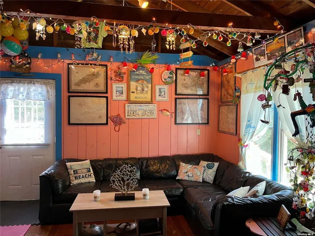 a living room with furniture and a painting on the wall