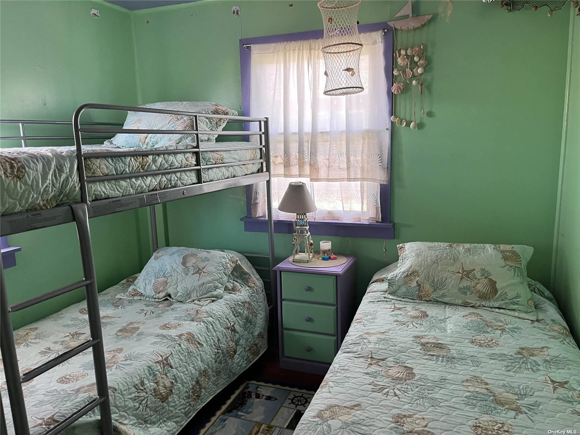 4 Surf View Walk Ocean Beach, NY 11770 - Photo 5 of 15 a bedroom with a bed and windows