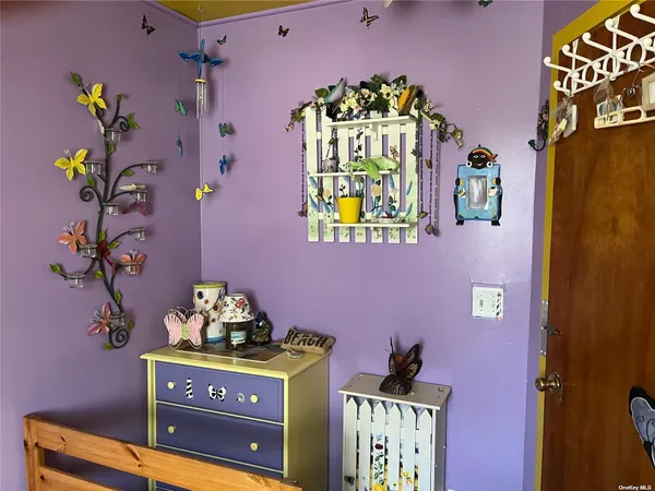 a bedroom with a bed next to a window