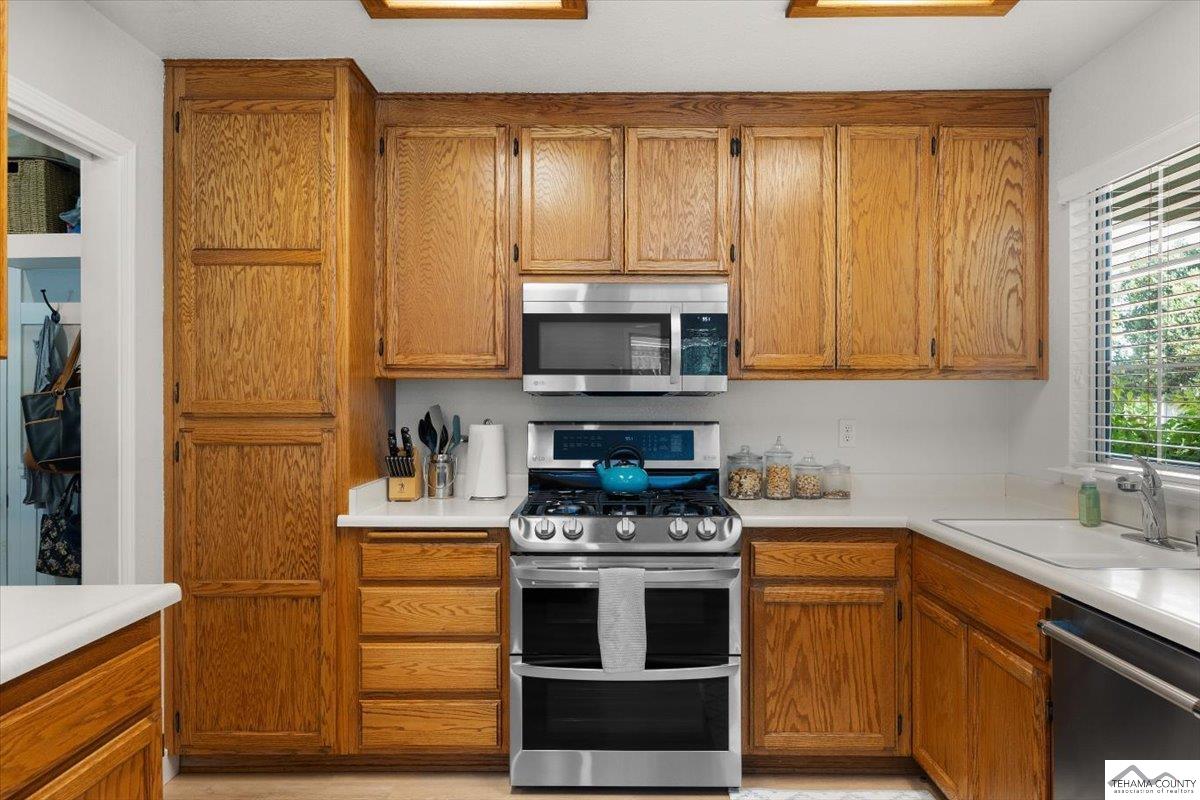 18887 Ridge Road Red Bluff, CA 96080 - Photo 15 of 48 a kitchen with stainless steel appliances granite countertop a stove a sink and a refrigerator