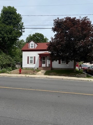 113 West Main Street, Unit 113 Ayer, MA 01432 - Photo 1 of 17 a front view of a house with a garden