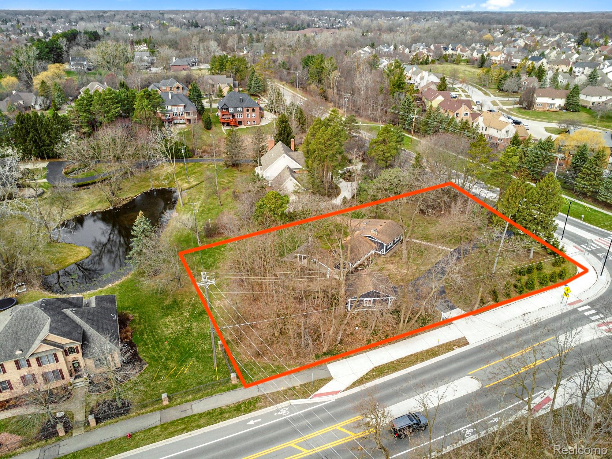 45401 West 9 Mile Road Novi, MI 48374 - Photo 65 of 67 Aerial perspective of suburban area featuring property parcel outlined and a large body of water
