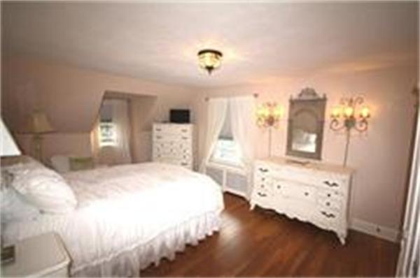 65 Shaker Road Longmeadow, MA 01106 - Photo 11 of 16 a bedroom with a bed and wooden floor