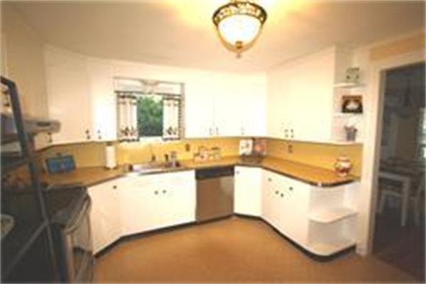 65 Shaker Road Longmeadow, MA 01106 - Photo 5 of 16 a kitchen with a sink and a refrigerator