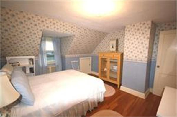 65 Shaker Road Longmeadow, MA 01106 - Photo 10 of 16 a spacious bedroom with a bed and a flat screen tv