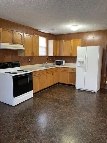 a kitchen with a sink stove and cabinets