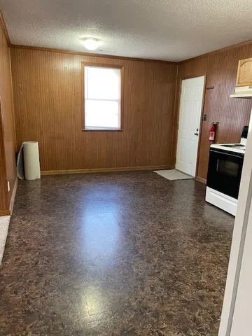 a view of a livingroom with furniture and a window