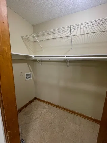 an empty room with a ceiling fan and window