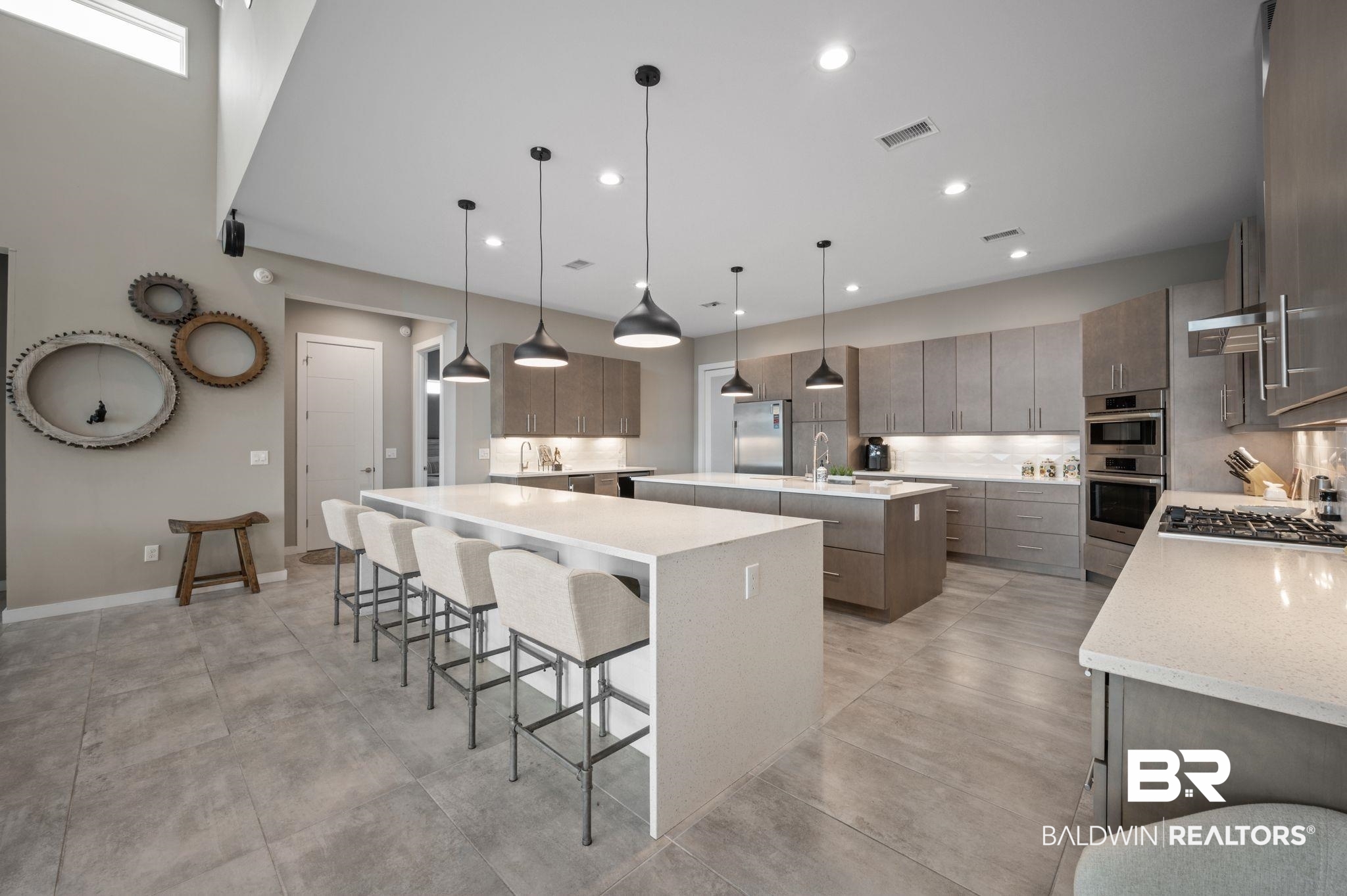 3840 Cotton Way Orange Beach, AL 36561 - Photo 11 of 75 Kitchen featuring pendant lighting, sink, appliances with stainless steel finishes, a large island, and a breakfast bar area