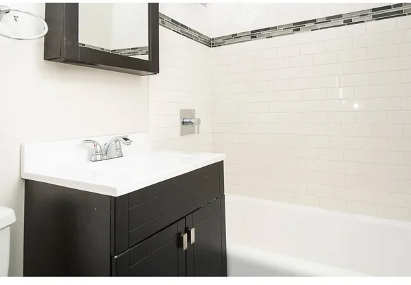 a bathroom with a sink vanity and a mirror