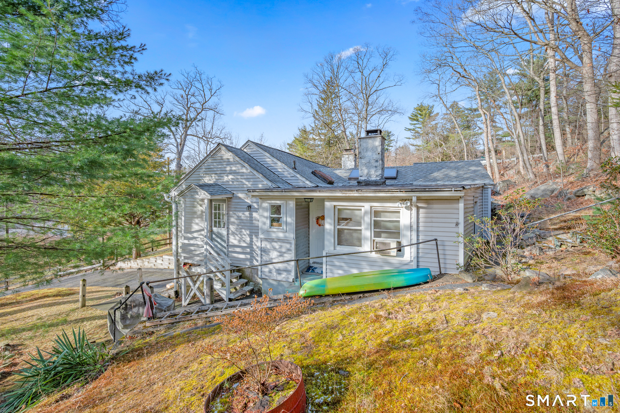 10 Old Waterbury Road Middlebury, CT 06762 - Photo 9 of 12 a front view of a house with a yard table and chairs