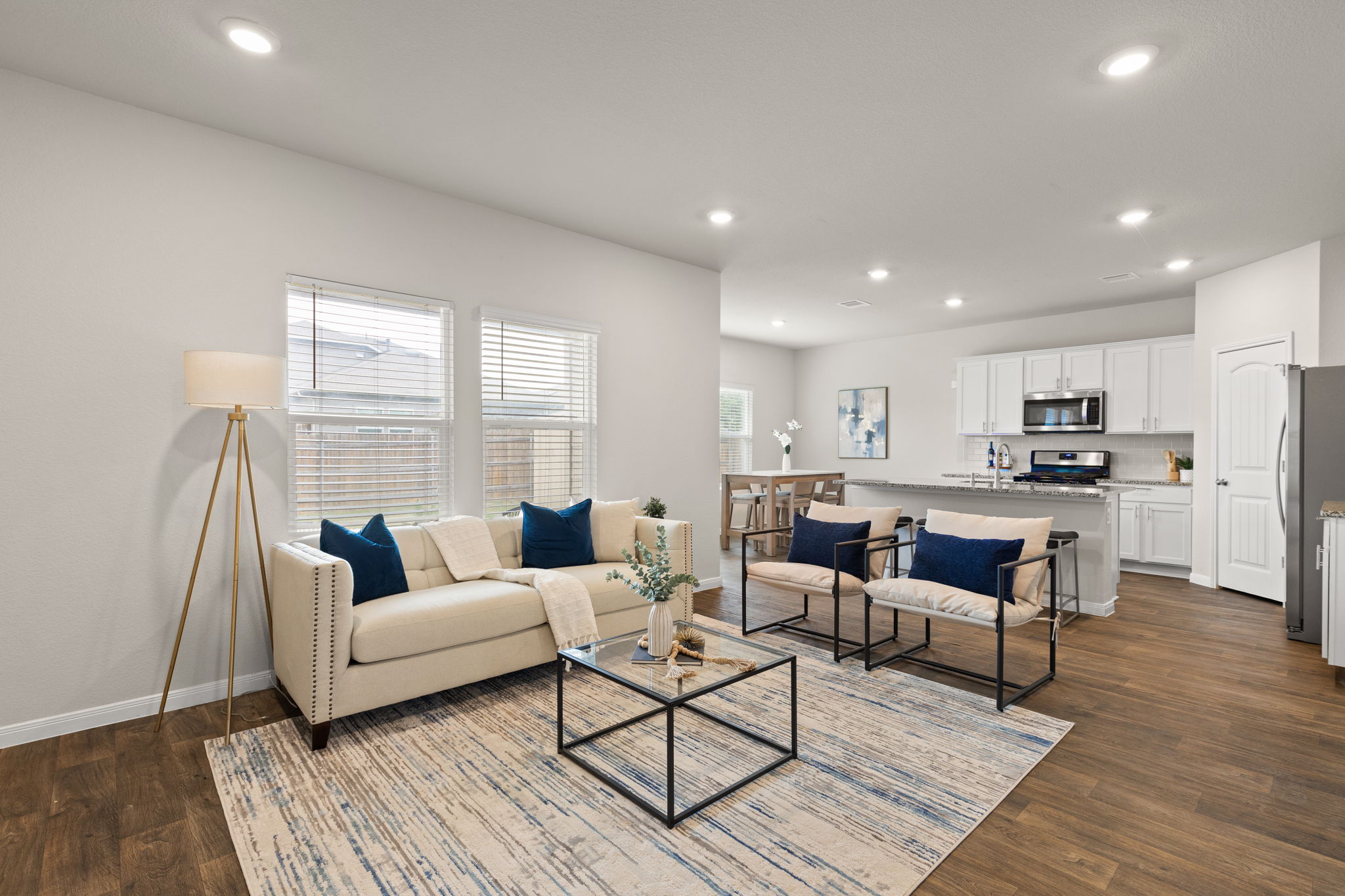 281 Jayden Drive Kyle, TX 78640 - Photo 1 of 36 Open-concept living space featuring wood-finish flooring, recessed lighting, and ample natural light from multiple windows