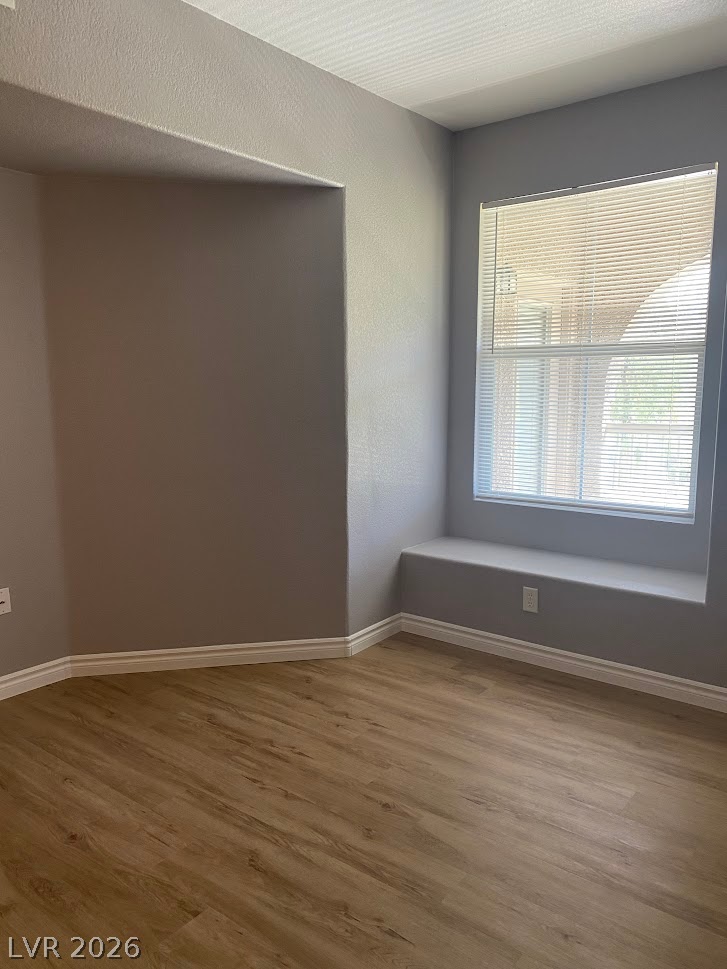 10550 West Alexander Road, Unit 2210 Las Vegas, NV 89129 - Photo 13 of 14 A well-lit room showcasing a built-in window seat and wood-look flooring.