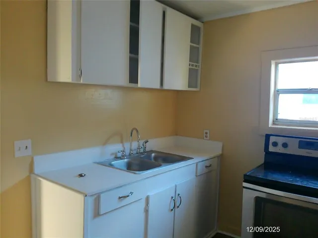 a kitchen with a sink and cabinets