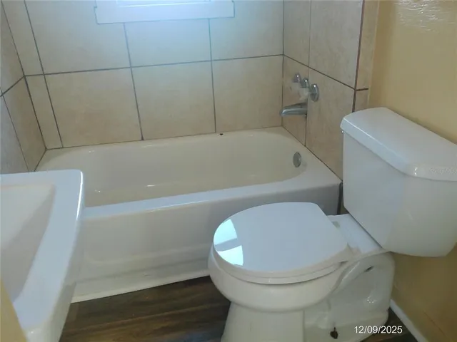 a bathroom with a toilet and bathtub