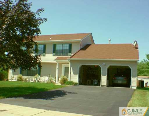45 Higgins Road Old Bridge, NJ 08857 - Photo 1 of 2 a view of a white house with a yard and plants