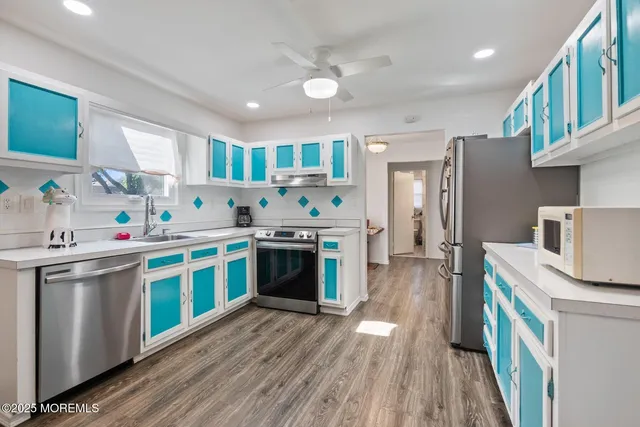 a kitchen with stainless steel appliances granite countertop a refrigerator stove and sink