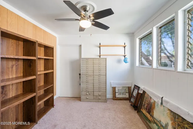 a bedroom with a bed chair and window