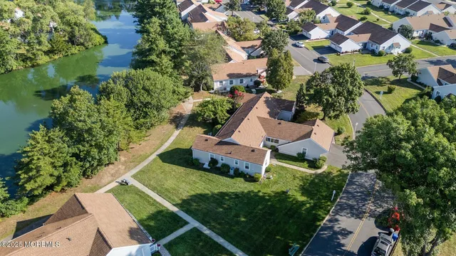 an aerial view of residential houses with outdoor space and street view