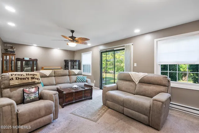 a kitchen with stainless steel appliances a stove a sink dishwasher a refrigerator white cabinets and wooden floor