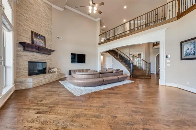 a view of a livingroom with fireplace staircase and hallway
