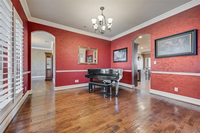 a work room with furniture and paintings on the wall