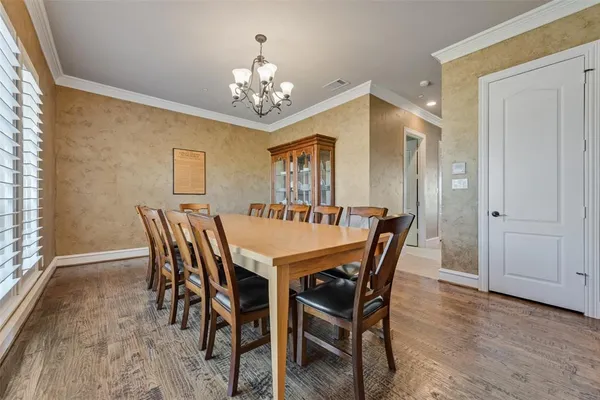 a view of a dining room with furniture and chandelier