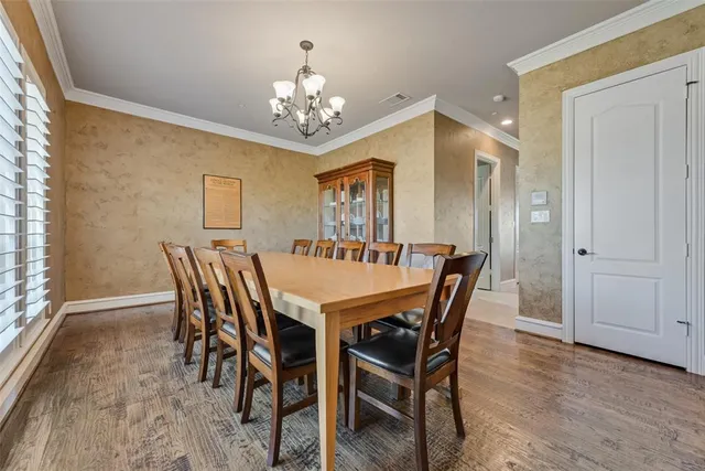 a view of a dining room with furniture and chandelier