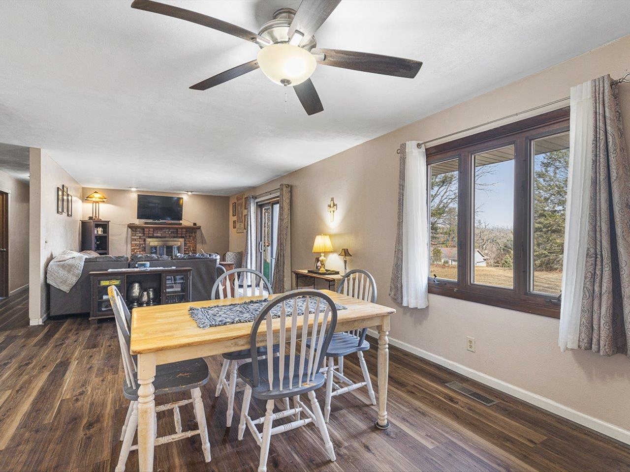 10383 Atwood Road Roscoe, IL 61073 - Photo 11 of 42 a view of a dining room with furniture window and wooden floor