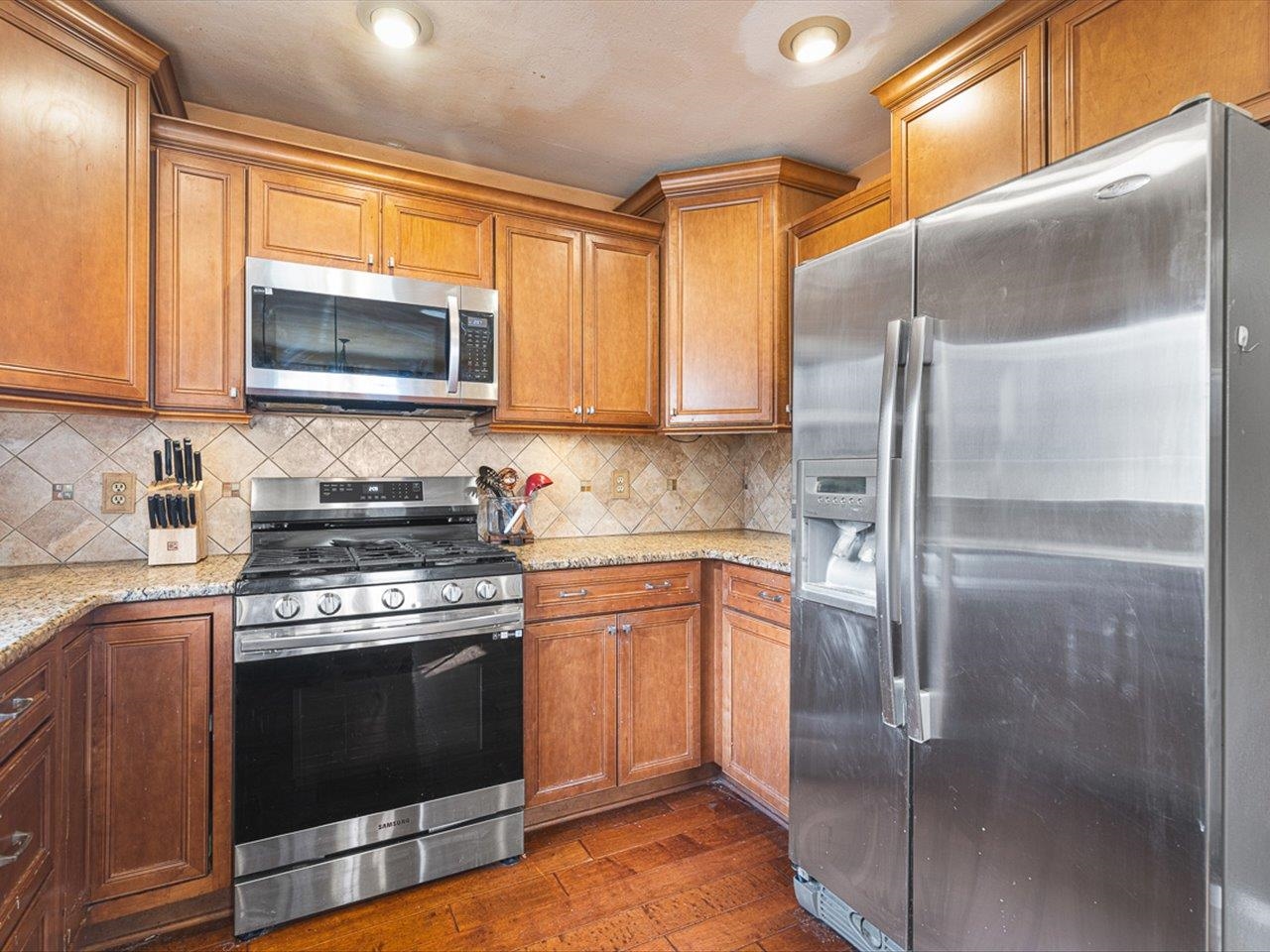 10383 Atwood Road Roscoe, IL 61073 - Photo 17 of 42 a kitchen with a stove microwave and refrigerator