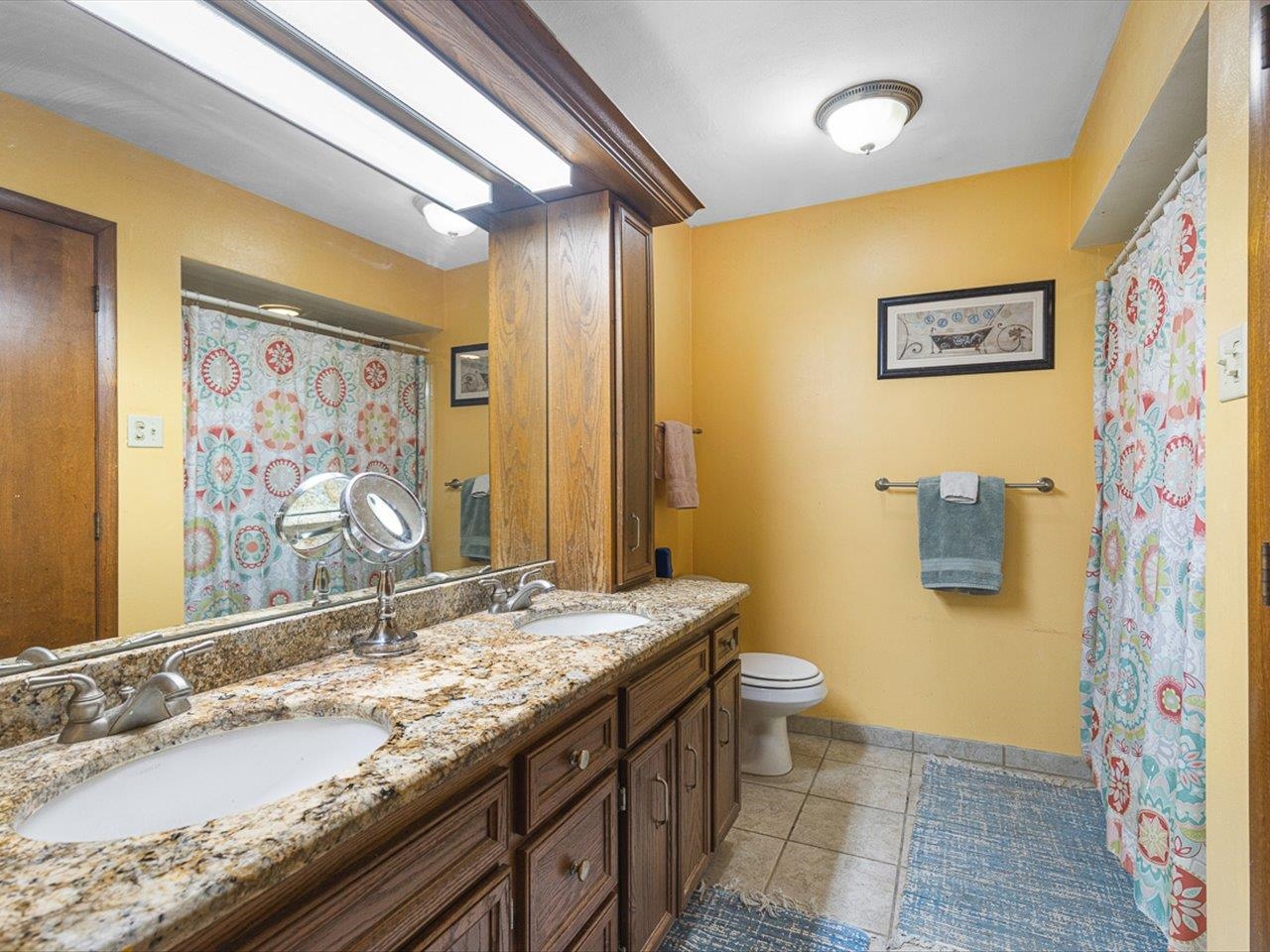 10383 Atwood Road Roscoe, IL 61073 - Photo 24 of 42 a bathroom with a granite countertop sink mirror vanity and toilet