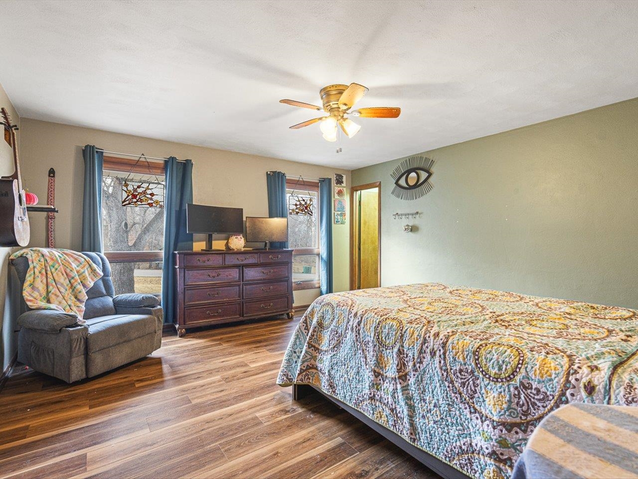 10383 Atwood Road Roscoe, IL 61073 - Photo 25 of 42 a bedroom with a bed and dresser with wooden floor