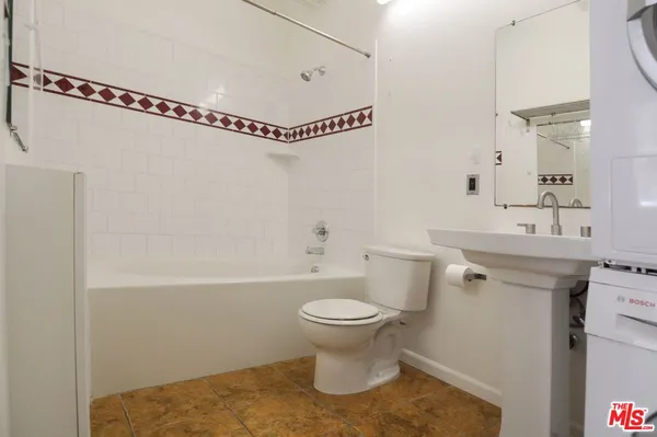 a bathroom with a sink a toilet and a shower