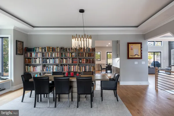 a living room with furniture tv and a floor to ceiling window