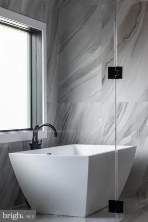 a bathroom with a sink a toilet a shower and a mirror