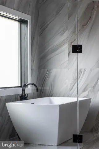 a bathroom with a sink a toilet a shower and a mirror